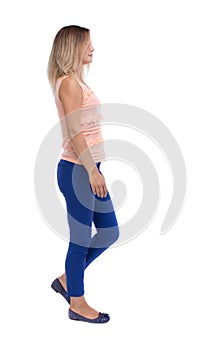Back view of walking woman. beautiful blonde girl in motion. b