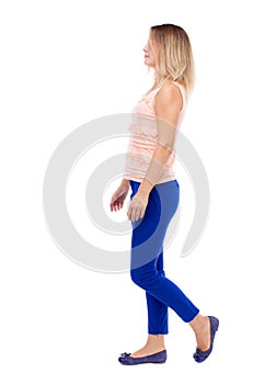 Back view of walking woman. beautiful blonde girl in motion. b