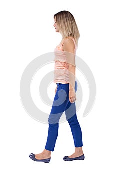 Back view of walking woman. beautiful blonde girl in motion. b