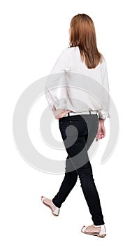 Back view of walking woman in jeans. beautiful blonde girl in m photo