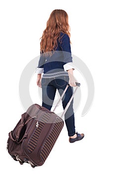 Back view of walking woman with suitcase