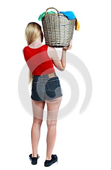 Back view of woman with basket of dirty laundry