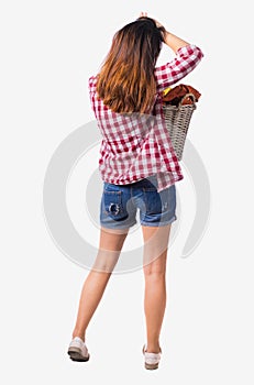 Back view of woman with basket dirty laundry. girl is engaged in washing.