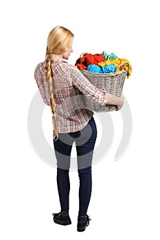 Back view of woman with basket dirty laundry. girl is engaged in washing
