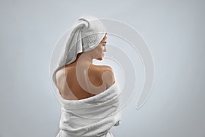 Back view of woman in bathrobe and towel. photo