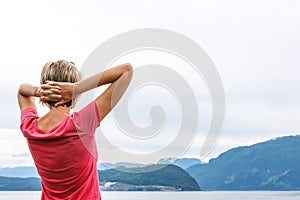 Back view of a woman enjoying a view at fjord