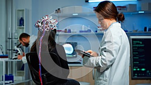 Back view of woman patient wearing performant eeg headset