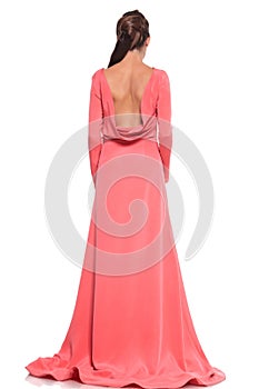 Back view of a woman in a pink gown with naked back