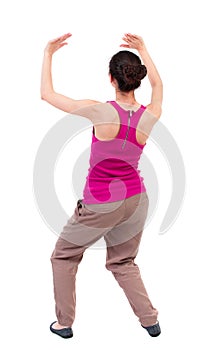 Back view of woman protects hands from what is falling