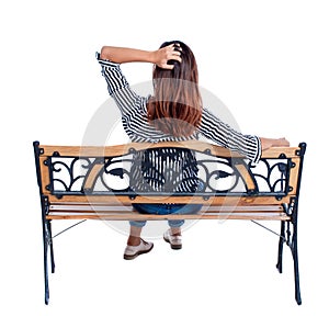 Back view of a woman sitting on bench