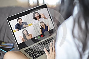 Back view of woman talking to video chat with colleagues using laptop webcam in video conference , Business team smart working