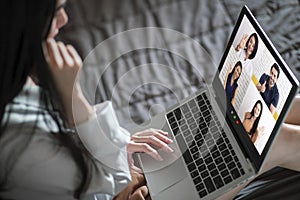 Back view of woman talking to video chat with colleagues using laptop webcam in video conference , Business team smart working