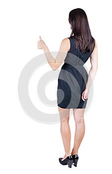 Back view of woman thumbs up