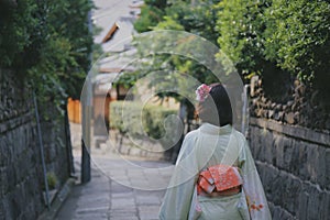 Back view of a woman in a traditional Japanese dress & x28;kimono& x29; walking down the street in Japan,Kyoto