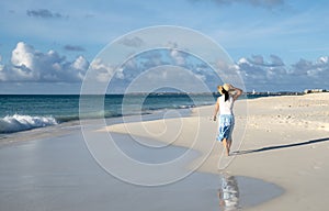 Back View of a Woman Walking Barefoot on a Caribbean Beach 6