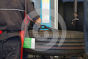 Back view workers inflate a new tires before change car tires