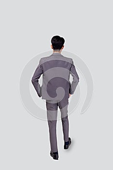 Back view young asian business man in suit walking isolated on white background, portrait of executive or manager.