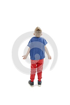 Back view of young boy confusing. Shocked little boy with hands up.