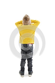 Back view of young boy confusing. Shocked little boy with hands on head. Noise, stress and people concept