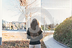 Back view of a young business woman in a financial building area