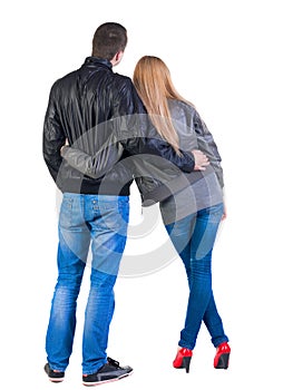 Back view of young couple (man and woman) look into the distance