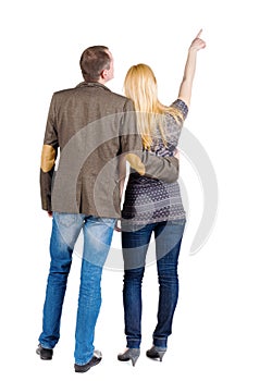 Back view of young couple pointing