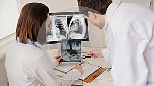 Back view of young doctors radiologists analises x-ray