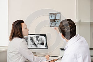 Back view of young doctors radiologists analises x-ray