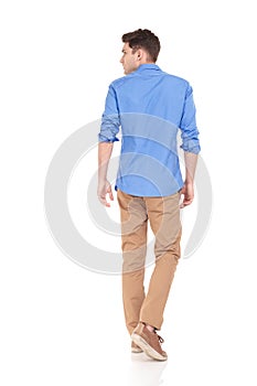 Back view of a young fashion man walking