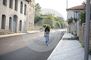 Back view of a young female in the streets of Karabakh