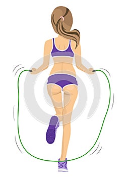 Back view of young fitness woman jumping rope