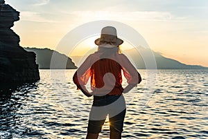 back view of young girl over sea sunset on Amalfi coast. Travel, relax, vacation