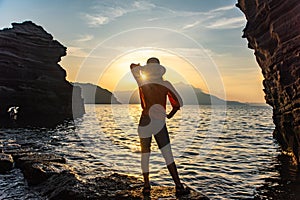 back view of young girl over sea sunset on Amalfi coast. Travel, relax, vacation