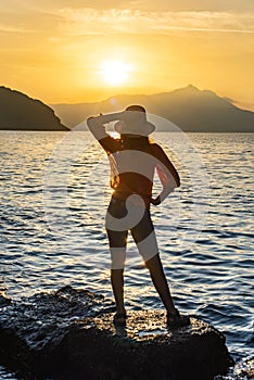 back view of young girl over sea sunset on Amalfi coast. Travel, relax, vacation