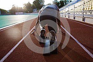 Back view of a young male athlete at starting block