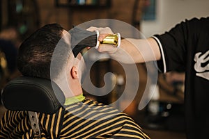 Back view of young man in barbershop. Hair care service concept