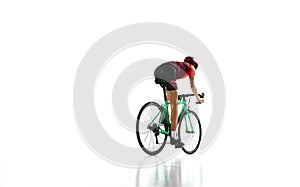 Back view. Young man, cyclist in sportswear and helmet riding bicycle, training isolated over white studio background.