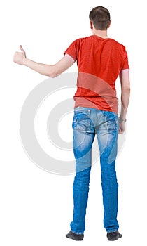 Back view of young men in orange t-shirt going thumb up.