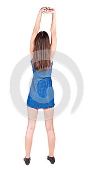 Back view of young woman limber up.