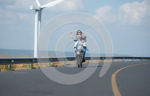 young woman riding a bicycle with her boyfriend on the road