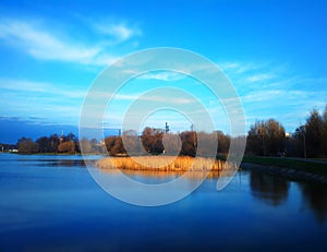 Back-water pond in sunset park background