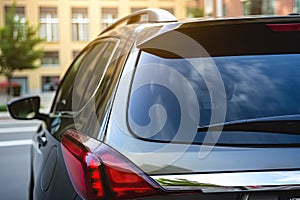 Back window of a car parked on the street, rear view. Mock-up for sticker or decals