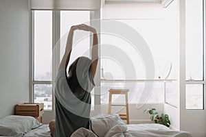 Back of woman just wake up and looking at the view in the morning.