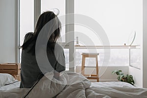 Back of woman just wake up and looking at the view in the morning.