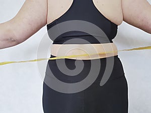 Back woman overweight centimeter fatness