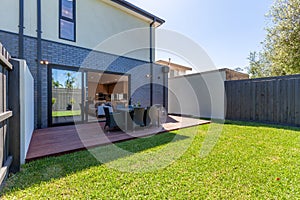 Back yard with deck and dining table in a typical suburb in Australia.