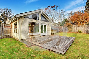 Back yard with deck and grass.