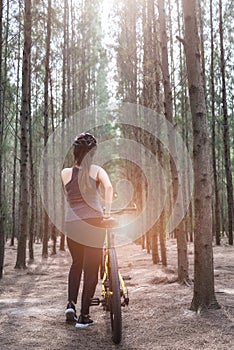 Back young female woman helmet catch bicycle