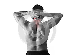 Back young muscular sport man holding sore neck touching massaging cervical area