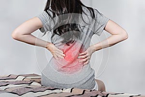 Backache and Lower back pain concept. Young woman suffering from back pain